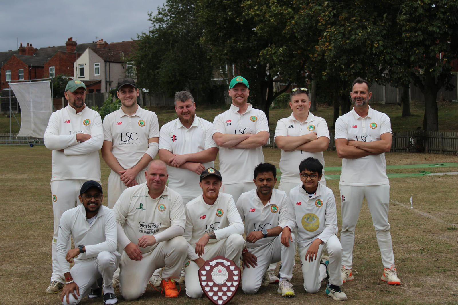 Second XI team celebrating on the field after securing the title